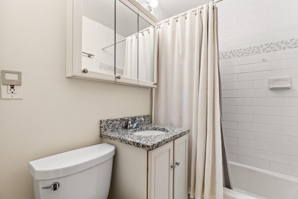 395 Broadway, Unit R5E Cambridge, MA 02139 - Photo 19 of 27 a bathroom with a granite countertop sink and a mirror