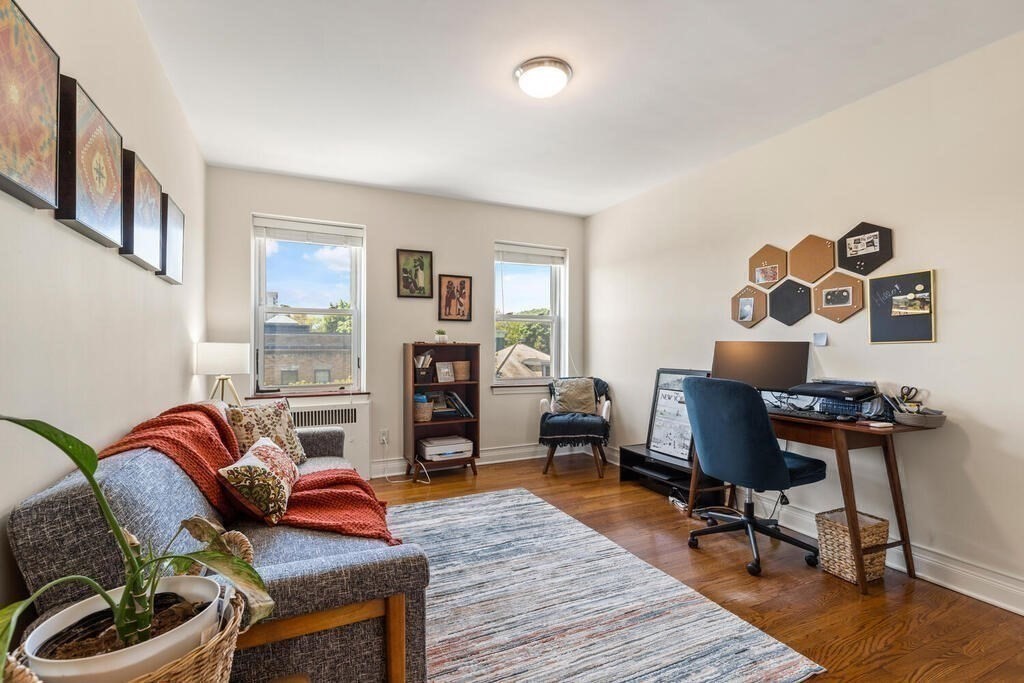 395 Broadway, Unit R5E Cambridge, MA 02139 - Photo 20 of 27 a living room with furniture and a piano