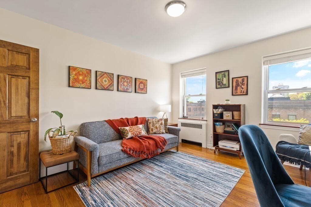 395 Broadway, Unit R5E Cambridge, MA 02139 - Photo 21 of 27 a living room with furniture and a wooden floor