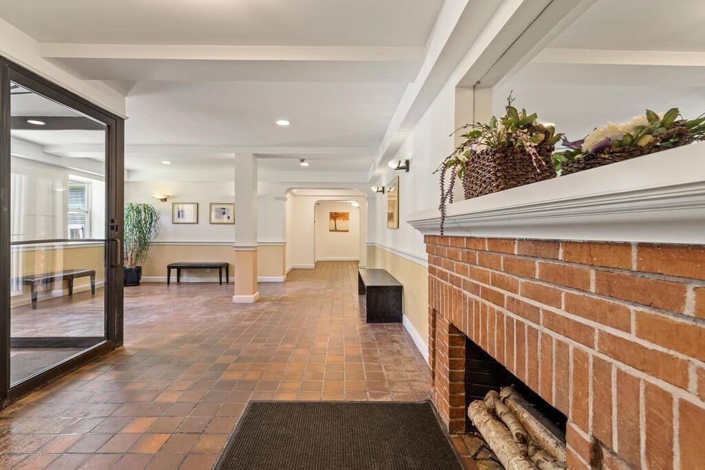 395 Broadway, Unit R5E Cambridge, MA 02139 - Photo 22 of 27 a view of an entryway with wooden floor and a rug