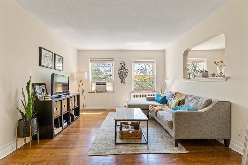 395 Broadway, Unit R5E Cambridge, MA 02139 - Photo 7 of 27 a living room with furniture and a flat screen tv