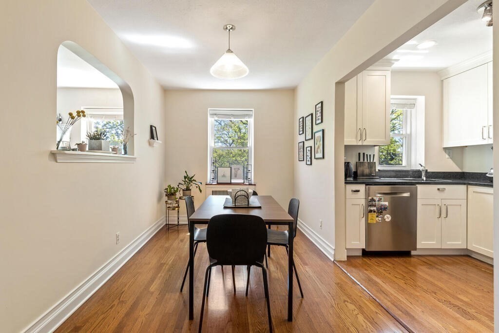 395 Broadway, Unit R5E Cambridge, MA 02139 - Photo 8 of 27 a view of a kitchen with furniture window and wooden floor