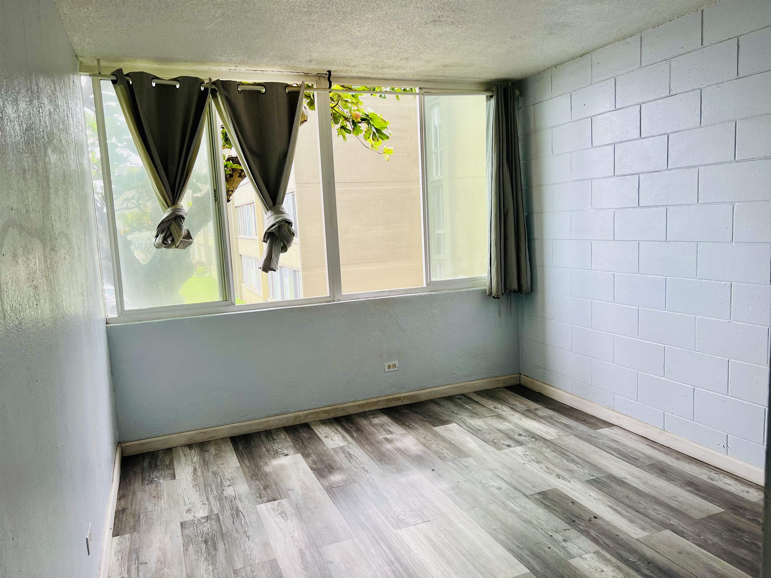111 Kahului Beach Road, Unit D225 Kahului, HI 96732 - Photo 15 of 31 a view of a closet with wooden floor and a window