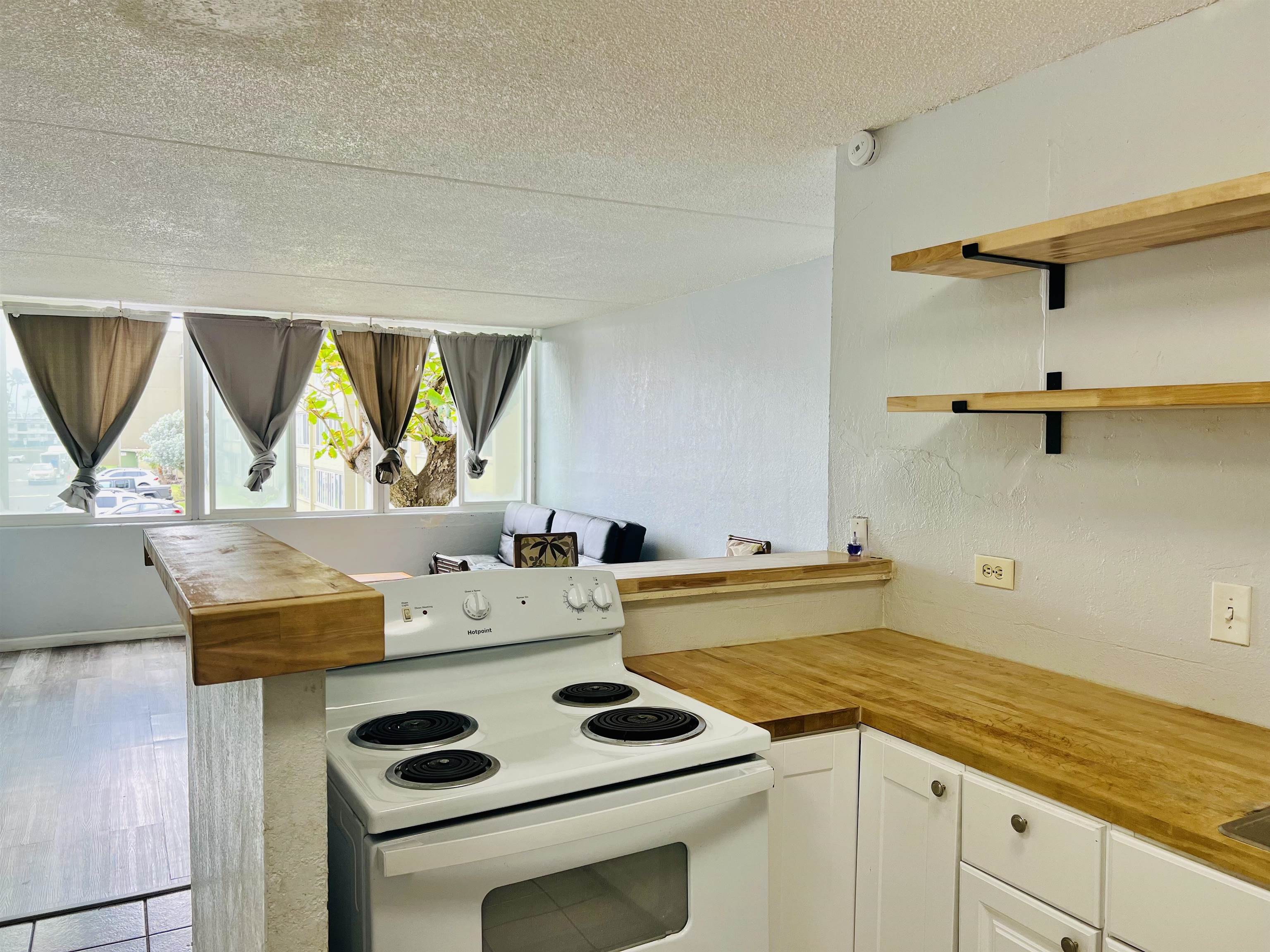 111 Kahului Beach Road, Unit D225 Kahului, HI 96732 - Photo 6 of 31 a kitchen with a stove a sink and a microwave