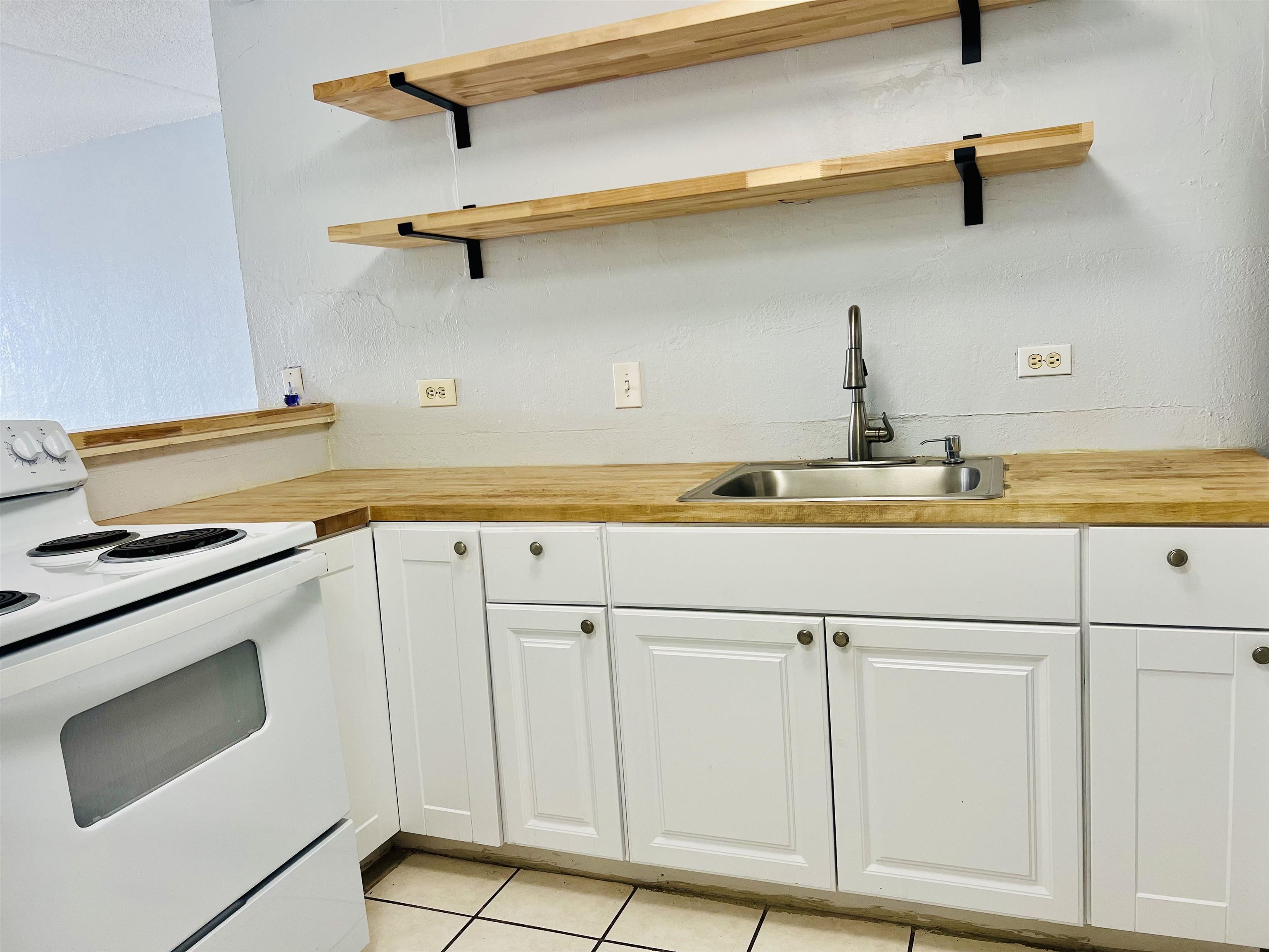 111 Kahului Beach Road, Unit D225 Kahului, HI 96732 - Photo 7 of 31 a kitchen with a sink and cabinets