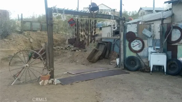 a backyard of a house with table and chairs