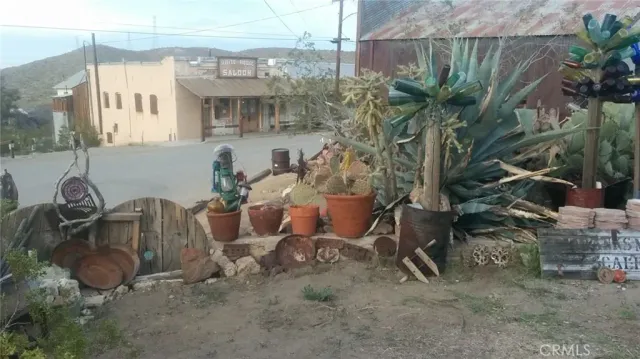 a view of a wooden house with a bench in backyard