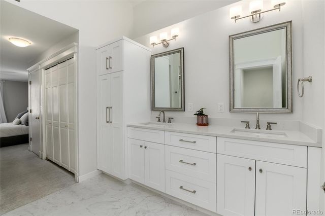 a bathroom with double sink and a mirror