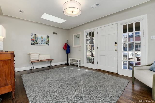 a kitchen with granite countertop cabinets stainless steel appliances and wooden floor