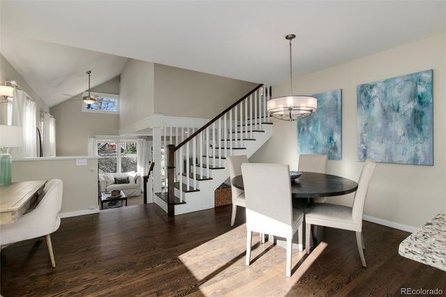 a view of entryway and dining room with wooden floor