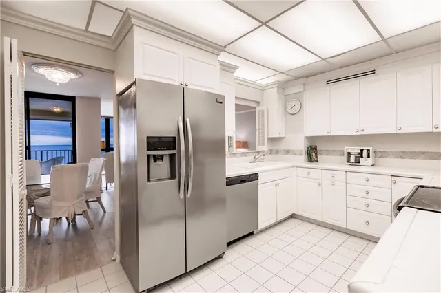 a kitchen with cabinets and stainless steel appliances