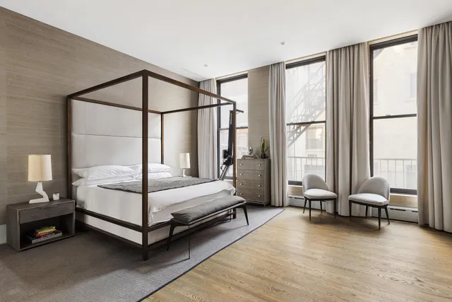 a bedroom with a bed and large window