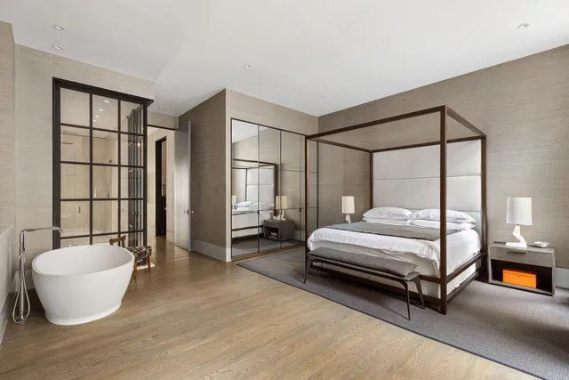 a spacious bedroom with a bed and a couch