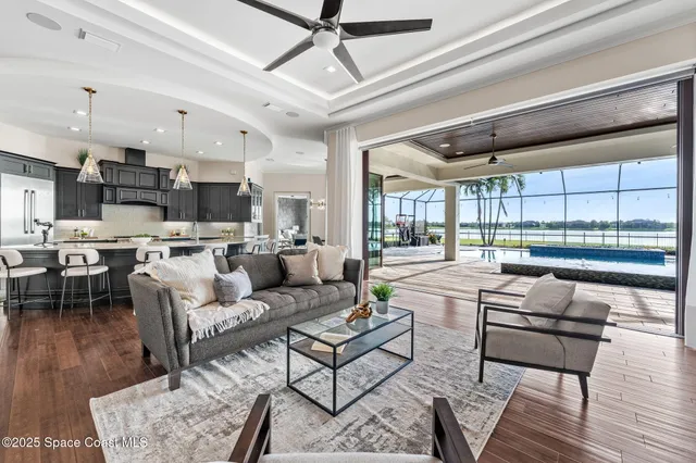 a kitchen with stainless steel appliances kitchen island granite countertop a dining table chairs and sink