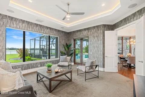 a spacious bathroom with a granite countertop sink a large mirror a bathtub and next to a window