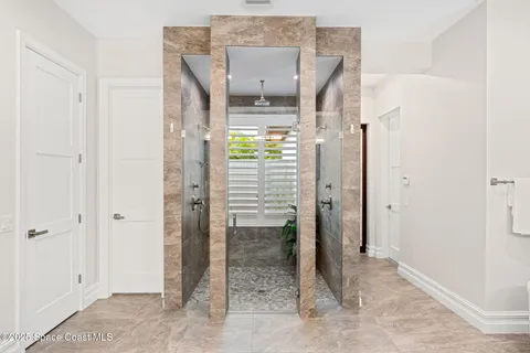 a bathroom with a granite countertop sink a toilet and a large mirror