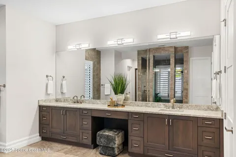 a bedroom with bed and a potted plant