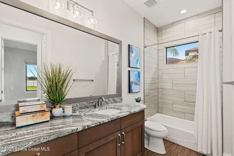 a bed room with a bed and a potted plant