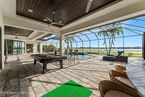 a view of a swimming pool with outdoor seating