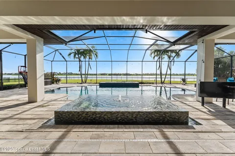 an aerial view of a house with a lake view