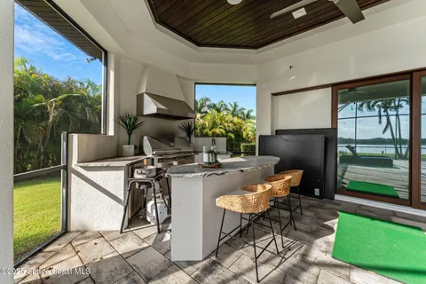 a front view of a house with swimming pool having outdoor seating