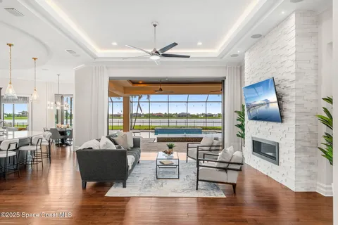 a living room with furniture and a floor to ceiling window