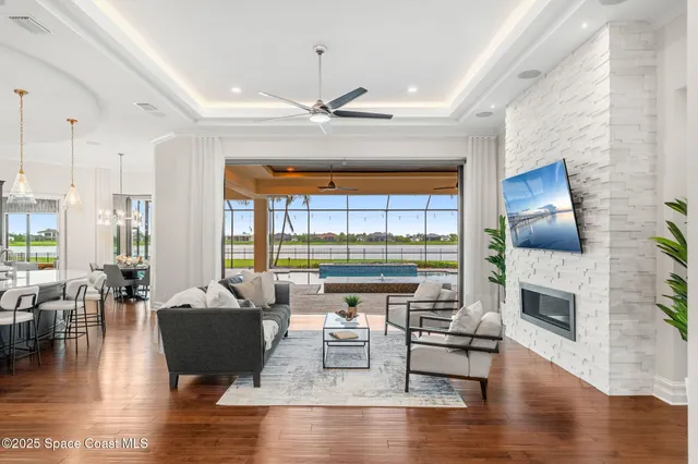 a living room with furniture and a floor to ceiling window