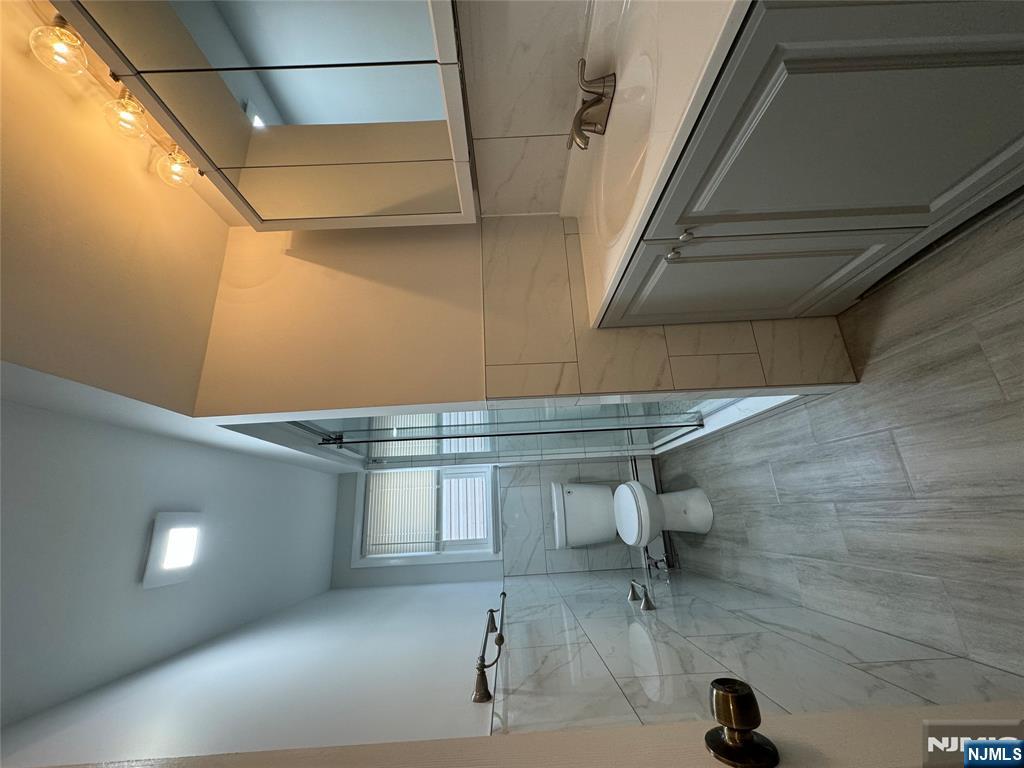 310 Elm Street, Unit 2R Kearny, NJ 07032 - Photo 13 of 14 a bathroom with a sink and mirror