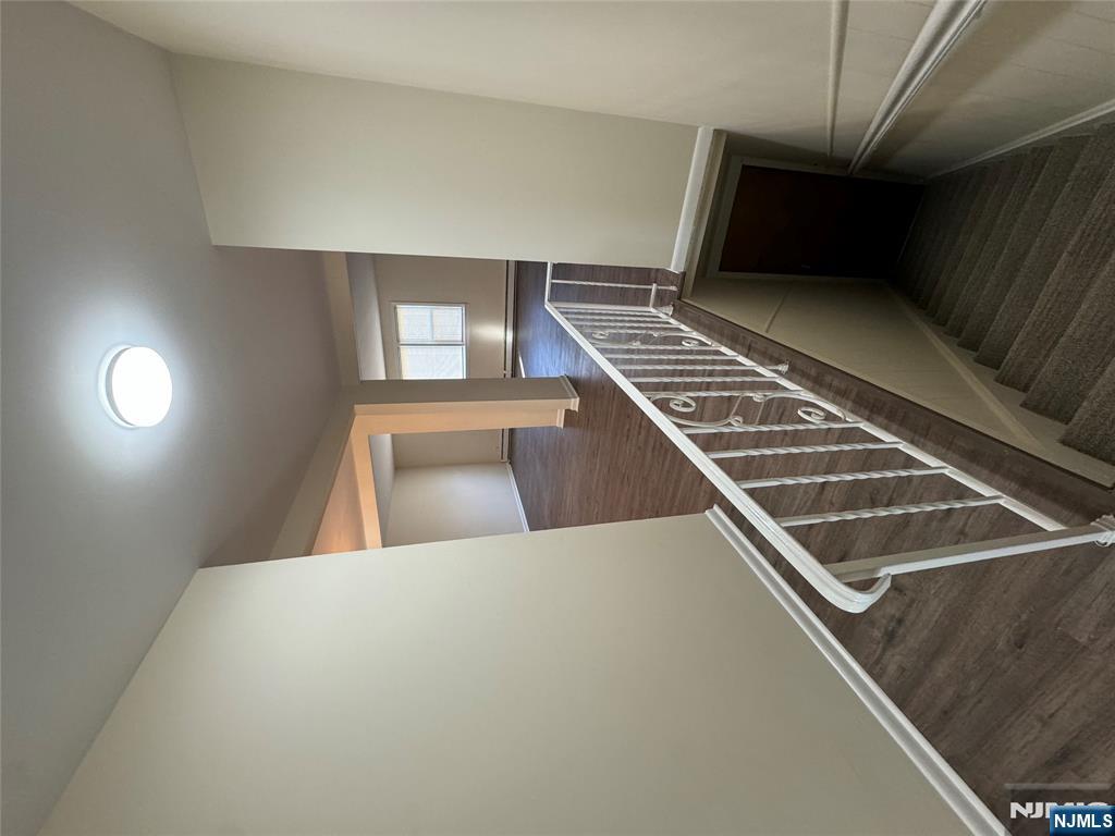 310 Elm Street, Unit 2R Kearny, NJ 07032 - Photo 2 of 14 a view of a hallway with wooden floor and staircase