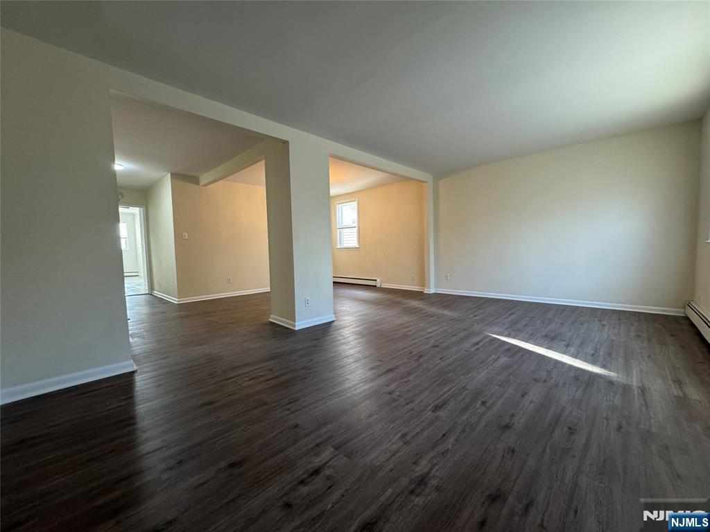 310 Elm Street, Unit 2R Kearny, NJ 07032 - Photo 5 of 14 an empty room with wooden floor and windows