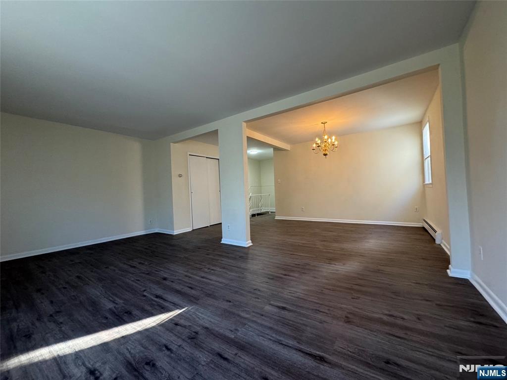 310 Elm Street, Unit 2R Kearny, NJ 07032 - Photo 6 of 14 a view of an empty room with wooden floor and a cabinet