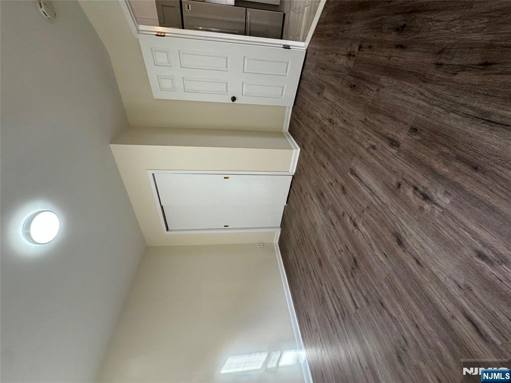 310 Elm Street, Unit 2R Kearny, NJ 07032 - Photo 9 of 14 wooden floor in an empty room with a window