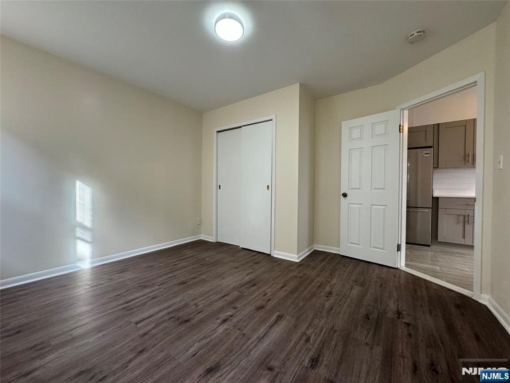 310 Elm Street, Unit 2R Kearny, NJ 07032 - Photo 10 of 14 an empty room with wooden floor