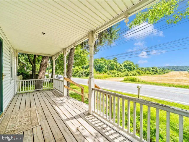 a view of a balcony with wooden floor