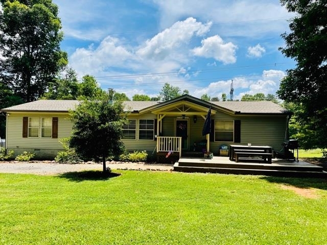 a view of a house with swimming pool and sitting area