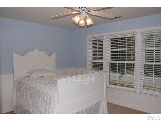 5100 Salem Ridge Road Holly Springs, NC 27540 - Photo 13 of 25 The secondary bedrooms are a good size with great closet space. This bedroom is wrapped with wainscoting and features a triple window. Bedroom