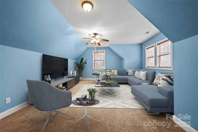 a living room with furniture a flat screen tv and a window