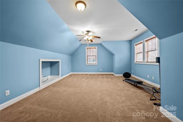 a view of a livingroom with a window and a ceiling fan