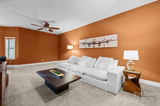 a living room with furniture and a lamp