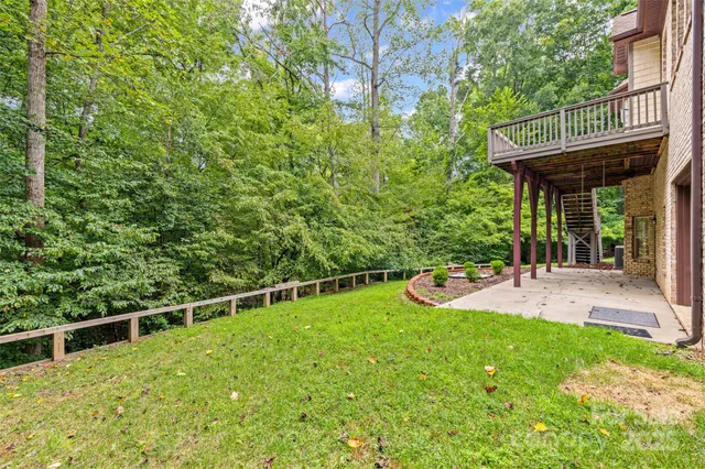 a view of a backyard with a wooden deck