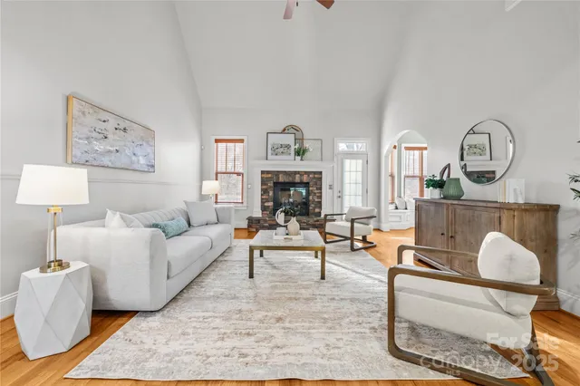 a living room with furniture a fireplace and decor
