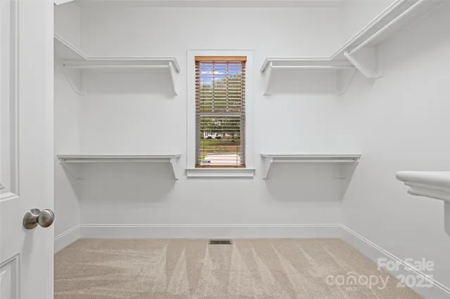 a view of an empty room with windows