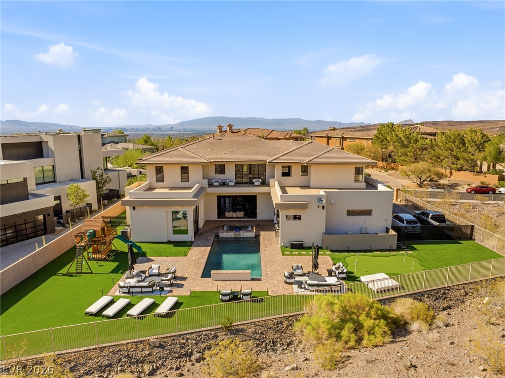 5 Crystal Tree Pass Henderson, NV 89052 - Photo 49 of 67 An exceptional outdoor haven with a private pool, lush green turf, and scenic desert views.