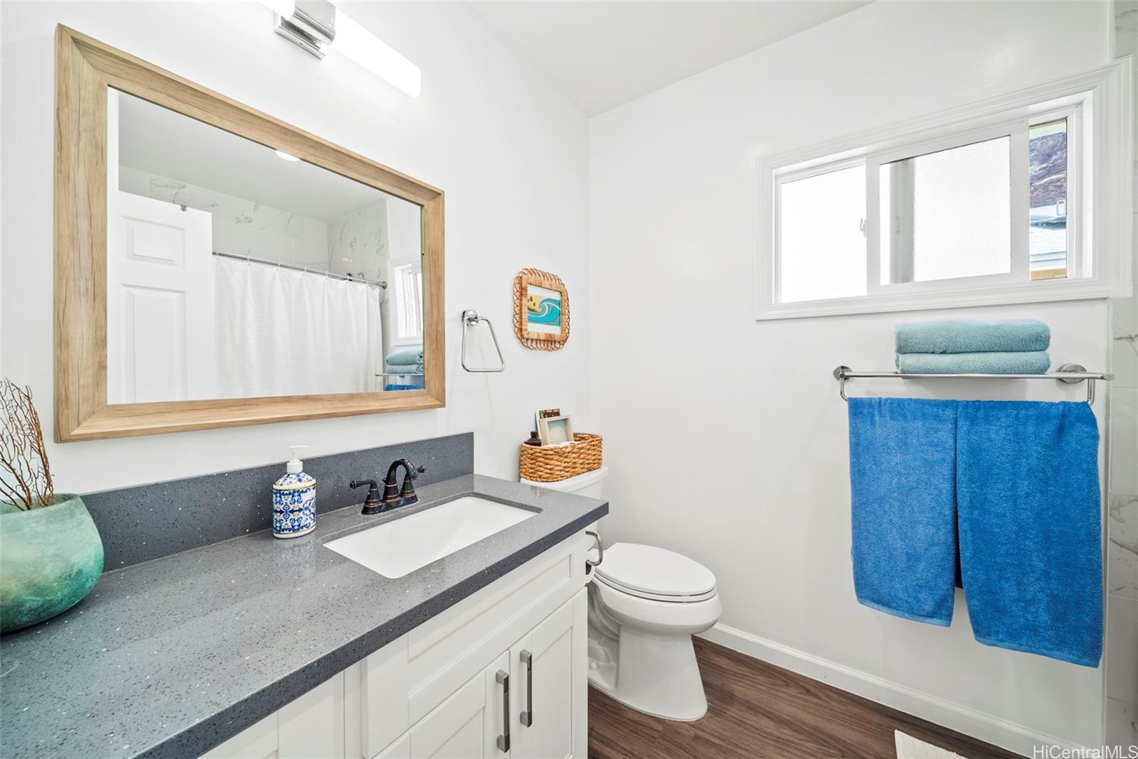 87-1446 Akowai Road Waianae, HI 96792 - Photo 13 of 23 a bathroom with a granite countertop sink mirror vanity and toilet