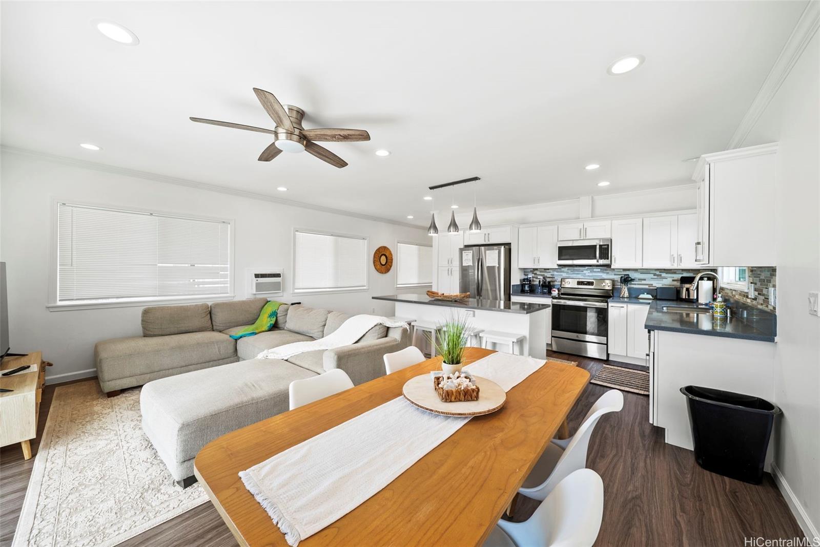 87-1446 Akowai Road Waianae, HI 96792 - Photo 2 of 23 a living room with stainless steel appliances furniture a rug kitchen view and a table