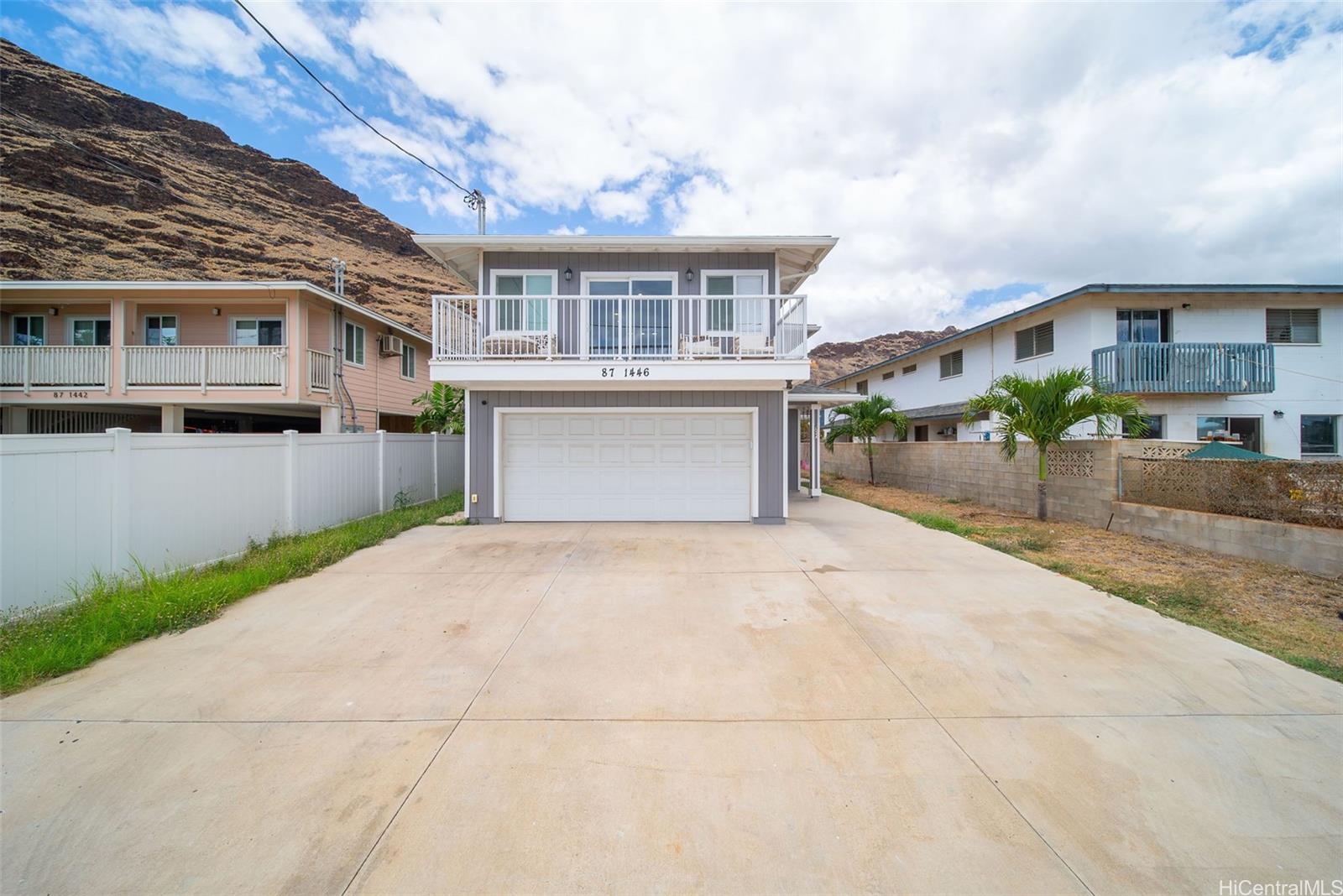 87-1446 Akowai Road Waianae, HI 96792 - Photo 21 of 23 a front view of a house with a yard and garage