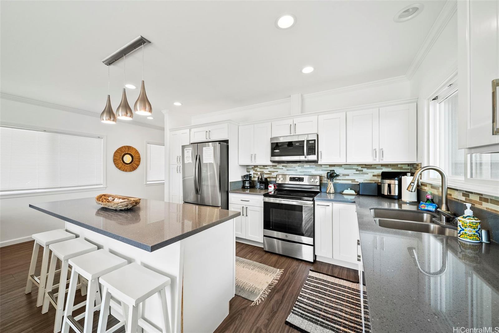 87-1446 Akowai Road Waianae, HI 96792 - Photo 3 of 23 a kitchen with stainless steel appliances granite countertop a stove top oven a refrigerator a sink and a stove