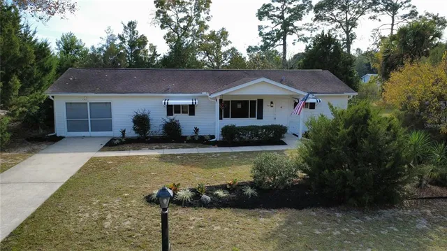 a view of a house with pool yard in front of it