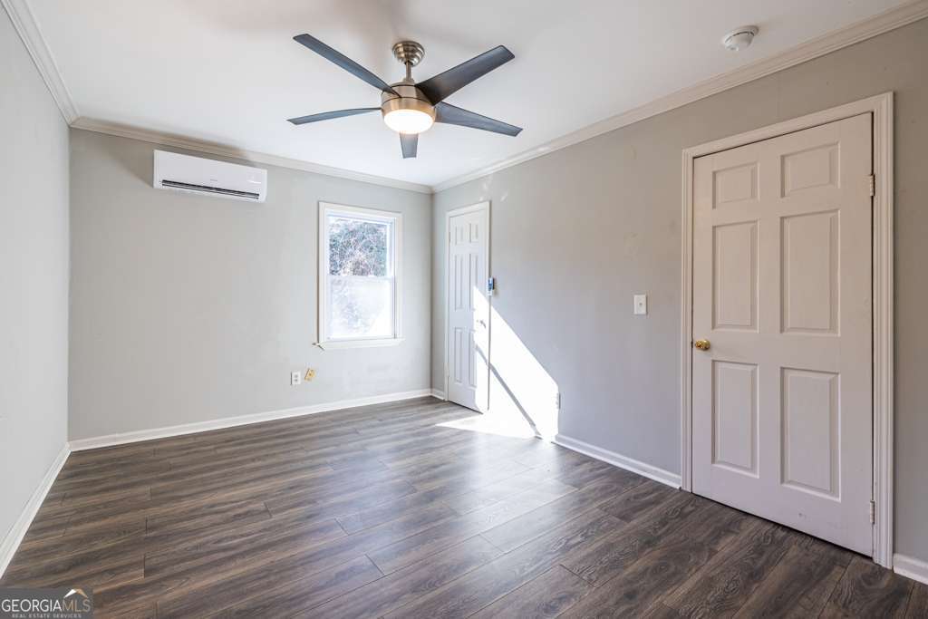 1570 Spring Lane Northwest, Unit B Atlanta, GA 30314 - Photo 16 of 26 an empty room with wooden floor and windows