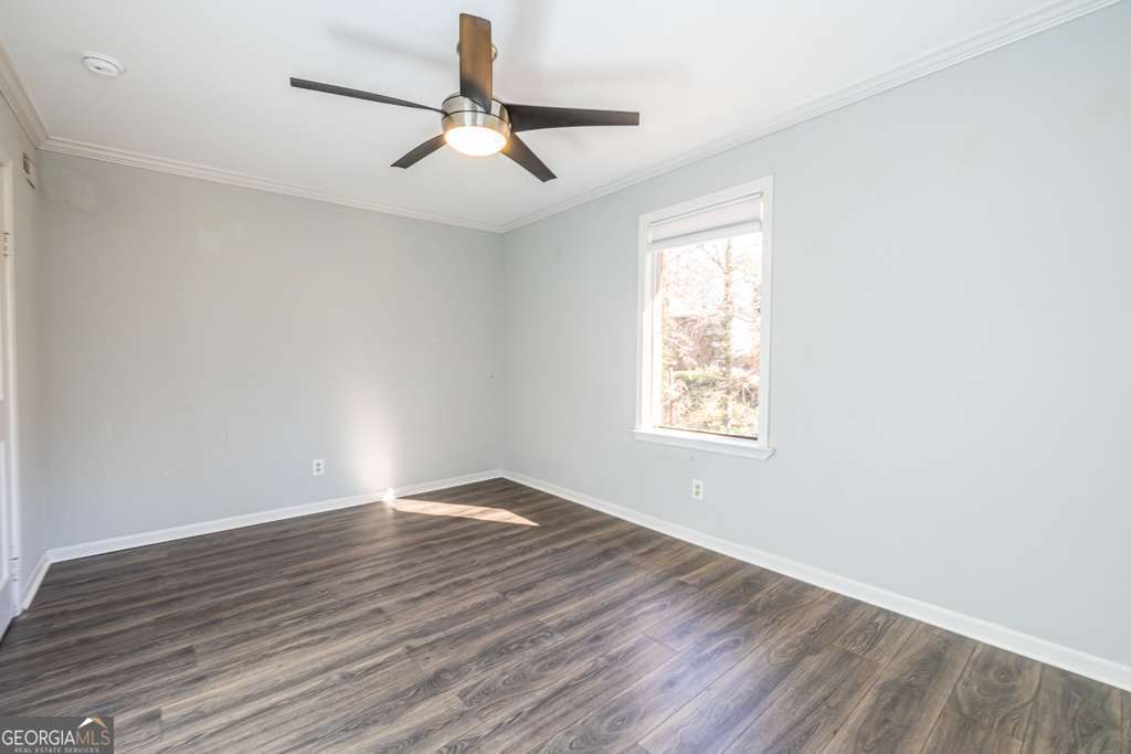 1570 Spring Lane Northwest, Unit B Atlanta, GA 30314 - Photo 17 of 26 a view of an empty room with wooden floor and a window